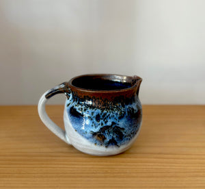 Glazed pottery milk jug
