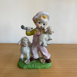 Kitsch boy with lambs